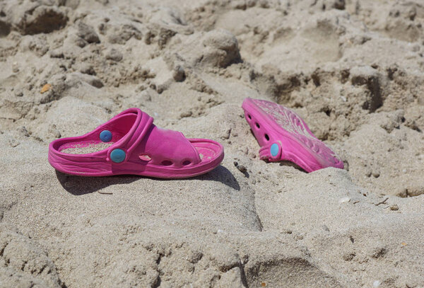 flip-flops on a sunny pile of sand . beach slipper on the beach