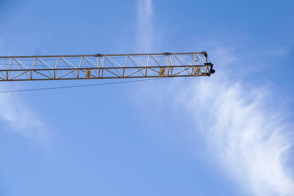 Part of arm machinery construction crane with blue sky background .