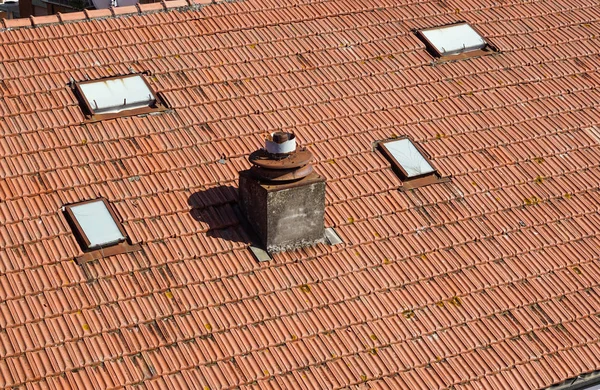 A close up view of a chimney on top of red roof tiles — Stock Photo, Image