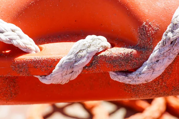 Life ring on the beach and sea knots. Close up.
