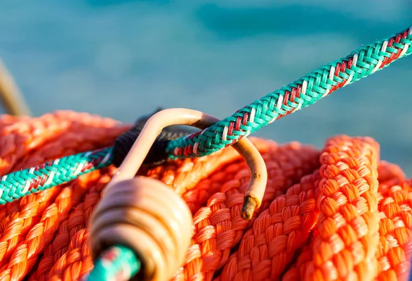 Hanging orange life belt with long rope at the beach, security and safety concept Stock Picture