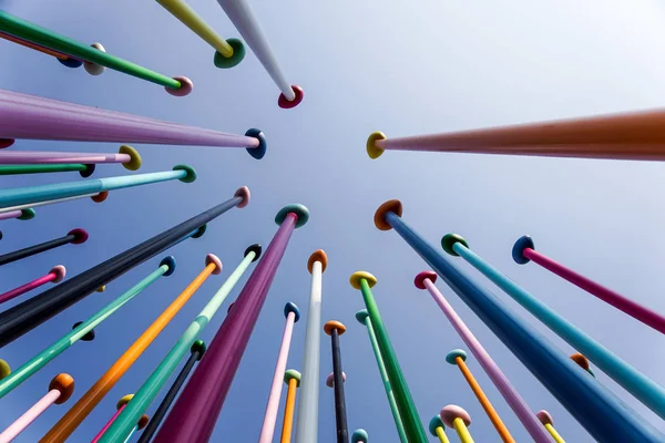 MILAN, ITALY 4 MAY 2019.: Low angle of colorful thin poles against blue sky. Positive and bright background concept .Abstract Modern Glass Financial Skyscraper Architecture Detail Royalty Free Stock Photos