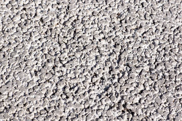 Világosszürke kavicsos kavicsos padló textúra, felülnézet. — Stock Fotó