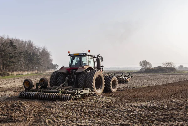 Traktör toprağı sürüyor.