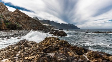 Atlantik Okyanusu 'nun öfkeli sörf Tenerife adasının kıyı kayalıkları üzerinde tatili ve küçük bir lagün aşağı yatıştırır.