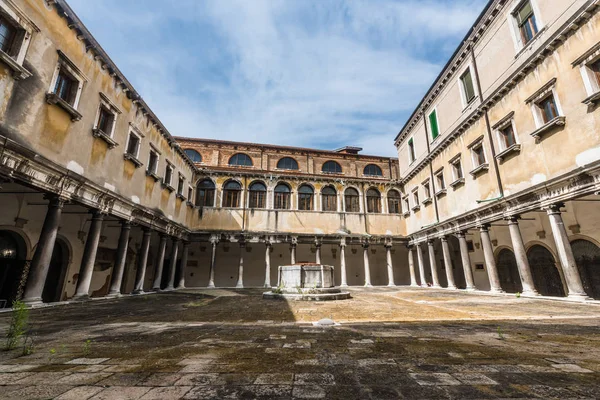 The old square courtyard of the old monastery in the center of Venice.