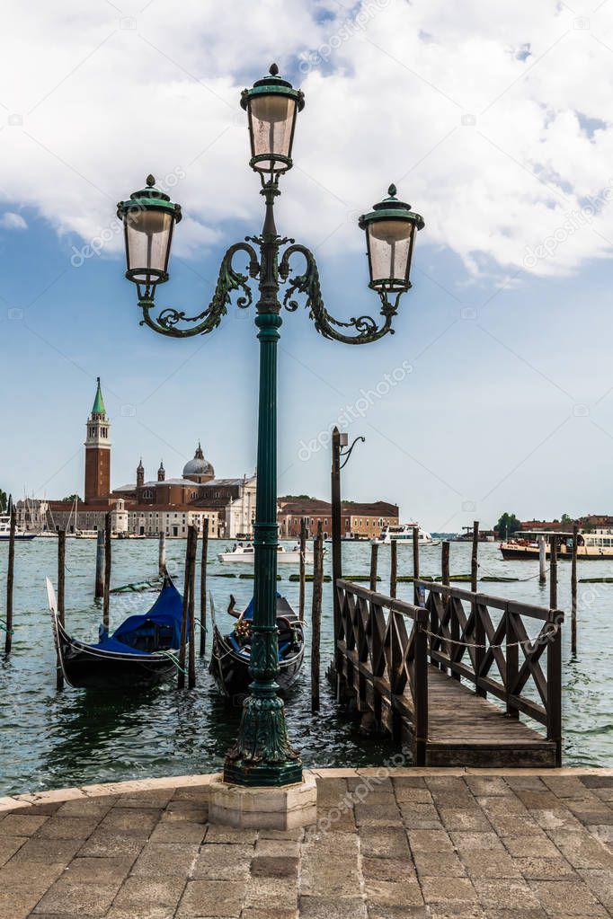 In the early morning you can enjoy a picturesque view of the Venetian gondolas at the pier on the waterfront and the island of San Giorgio Maggiore.