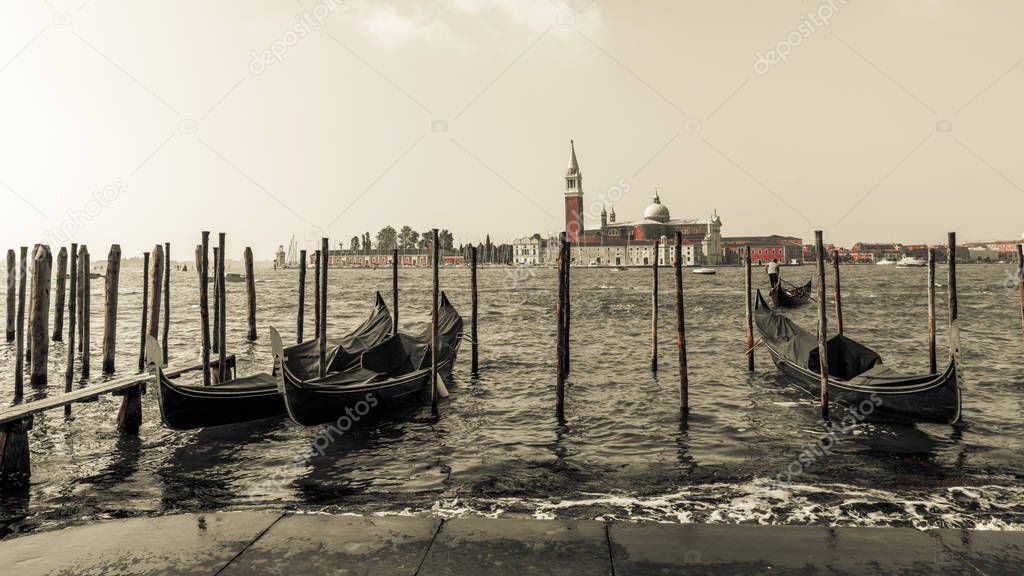In the early morning you can enjoy a picturesque view of the Venetian gondolas at the pier on the waterfront and the island of San Giorgio Maggiore.