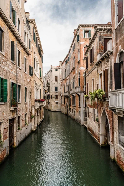 Old houses, washed by sea waters, stand along narrow canals in the heart of ancient Venice.