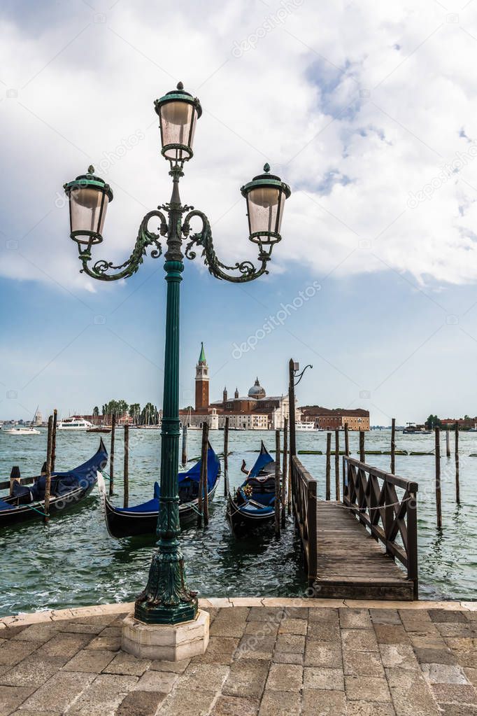 In the early morning you can enjoy a picturesque view of the Venetian gondolas at the pier on the waterfront and the island of San Giorgio Maggiore.