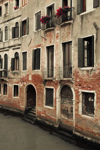 Old houses, washed by sea waters, stand along narrow canals in the heart of ancient Venice.