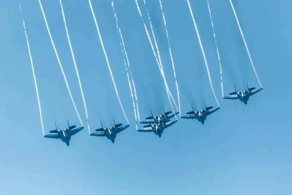 A group of military aircraft participate in demonstrations at the international air show.