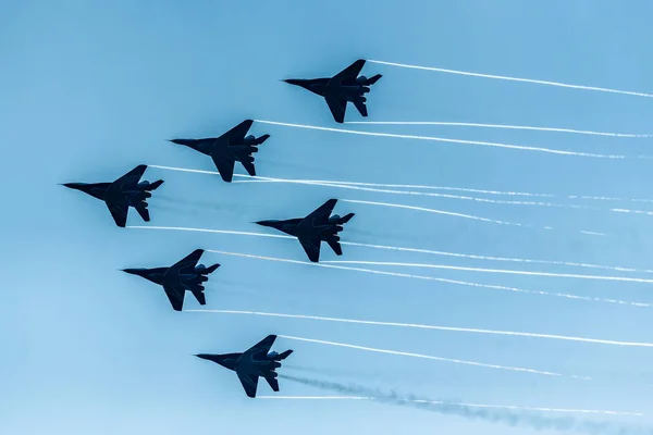 A group of military aircraft participate in demonstrations at the international air show.