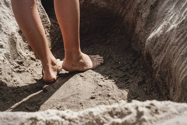 Close up of child feet in the sand. Summer vacations at the beach.