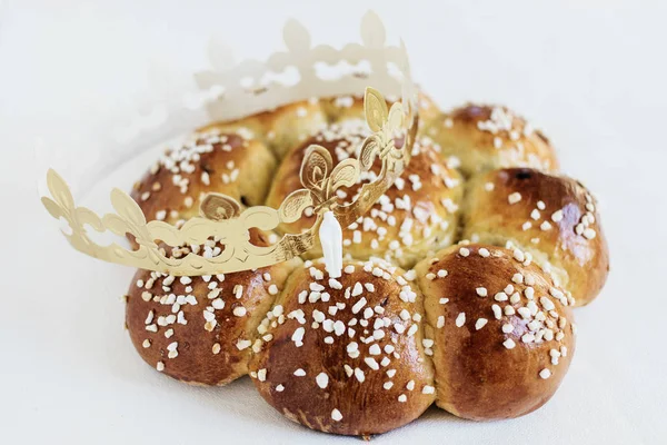 King Bread, called in German language Dreiknigskuchen, baked in Switzerland on January 6th. Small plastic miniature of the king is hidden inside of the bread. The person who finds it, is the king.