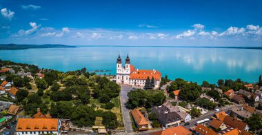 Tihany, Hungary - Aerial panoramic view of the famous Benedictine Monastery of Tihany (Tihany Abbey) with beautiful coloruful Lake Balaton at background clipart
