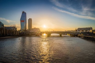 London, United Kingdom - Sunset at Blackfriars bridge and station with skyscraper at background clipart