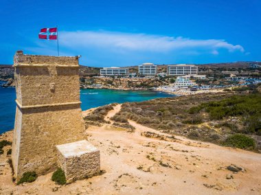 Ghajn Tuffieha, Malta - Beautiful Ghajn Tuffieha Watch Tower and Golden Bay beach on a bright summer day with clear blue sky clipart