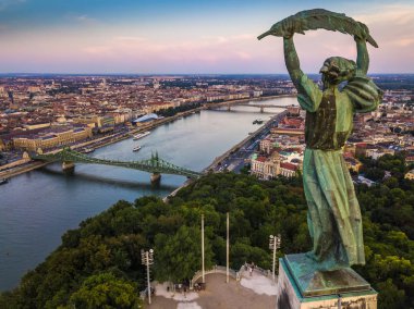 Budapest, Hungary - Aerial view of the Statue of Liberty at sunset with skyline of Budapest, Libery Bridge and River Danube at background clipart