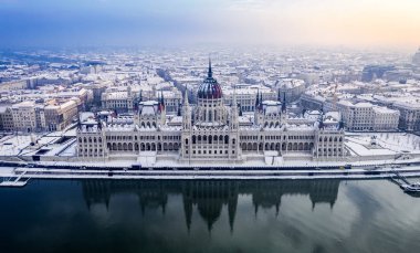 Budapest, Hungary - Aerial view of the beautiful snowy Parliament of Hungary and skyline of Pest at winter time clipart