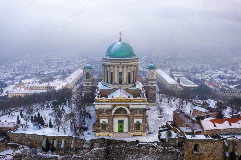Esztergom, Hungary - Aerial view of the beautiful snowy Basilica of Esztergom on a foggy winter morning