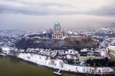 Esztergom, Hungary - Aerial skyline view of Esztergom with the beautiful snowy Basilica on a foggy winter morning clipart