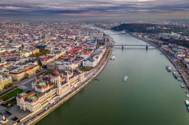 Budapest, Hungary - Aerial drone view of the beautiful Hungarian Parliament building at sunset with St. Stephen's Basilica, Szechenyi Chain Bridge, sightseeing boat on River Danube and yellow tram clipart