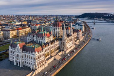 Budapest, Hungary - Aerial drone view of the beautiful Hungarian Parliament building at sunset with warm colors and blue sky. St.Stephen's Basilica, Szechenyi Chain Bridge, Elisabeth Bridge and Statue of Liberty at background clipart