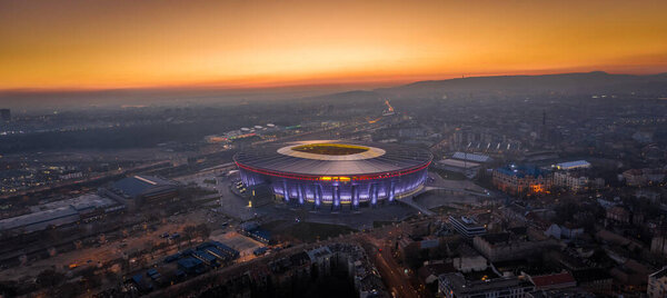 Budapest, Hungary - Aerial high resolution panoramic shot of Budapest at dusk with a beautiful golden sunset. This view includes the brand new illuminated Ferenc Puskas Stadium or Puskas Arena