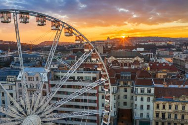 Budapeşte, Macaristan - Budapeşte 'nin ünlü dönme dolabının havadan görünüşü ve Buda Kalesi Kraliyet Sarayı ve inanılmaz altın bir gün batımı ve arka planda gökyüzü. Tekerlek Elisabeth Meydanı 'nda bulundu (Erzsebet ter)
