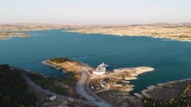 Altın ışık su ve tarlalara yansıyor. 4K sakin nehir manzarası tarım arazileri boyunca akıyor.