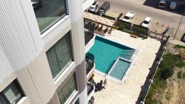 Newly built luxury apartments with glass balconies near the sea.