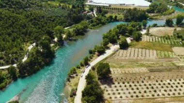 Çiftlik arazileri ve ağaçlar arasındaki su sporunun en üst düzey drone görüntüsü.