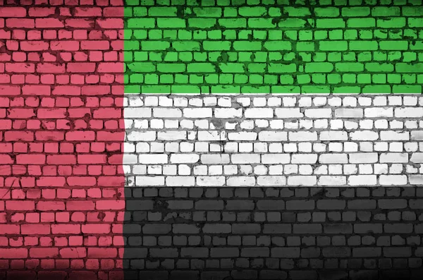 United Arab Emirates flag is painted onto an old brick wall