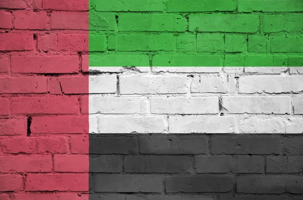 United Arab Emirates flag is painted onto an old brick wall