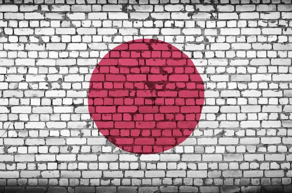Japan flag is painted onto an old brick wall