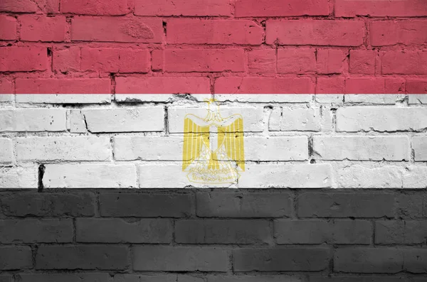 Egypt flag is painted onto an old brick wall