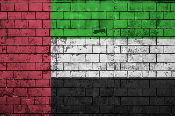 United Arab Emirates flag is painted onto an old brick wall