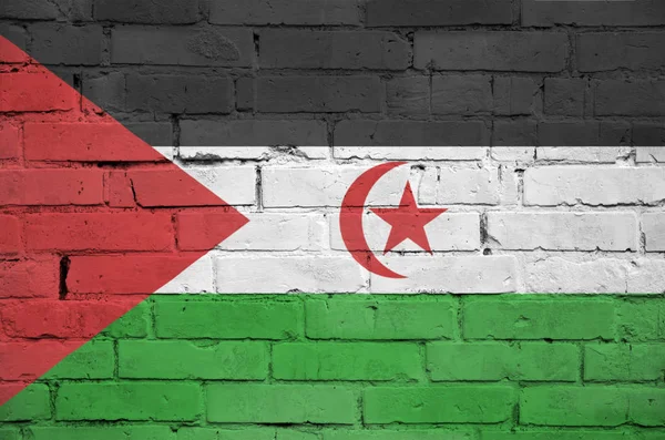 Western Sahara flag is painted onto an old brick wall