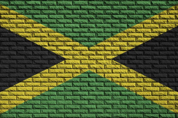 ジャマイカの旗は古いレンガの壁に描かれています — ストック写真