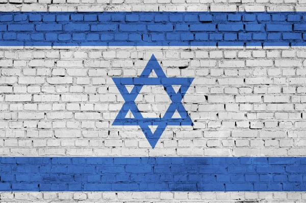 Israel flag is painted onto an old brick wall