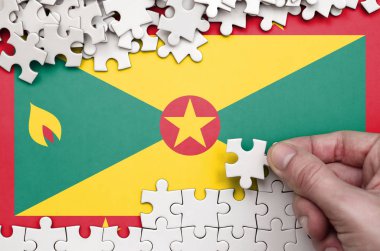 Grenada bayrağı üzerinde insan el kıvrımlar bir bulmaca beyaz renk bir tablo üzerinde tasvir.