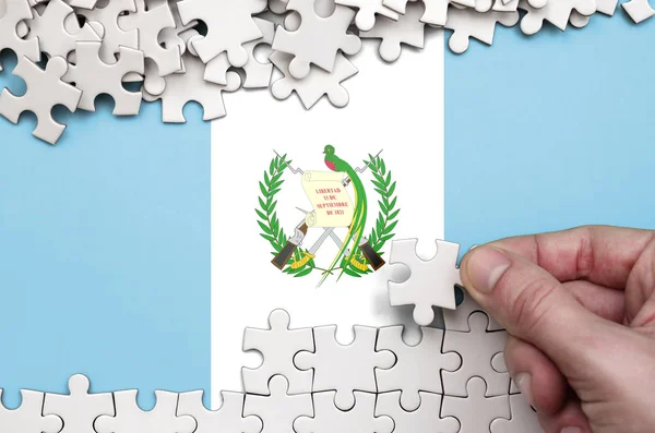 Guatemala Flag Depicted Table Which Human Hand Folds Puzzle White — Stock Photo