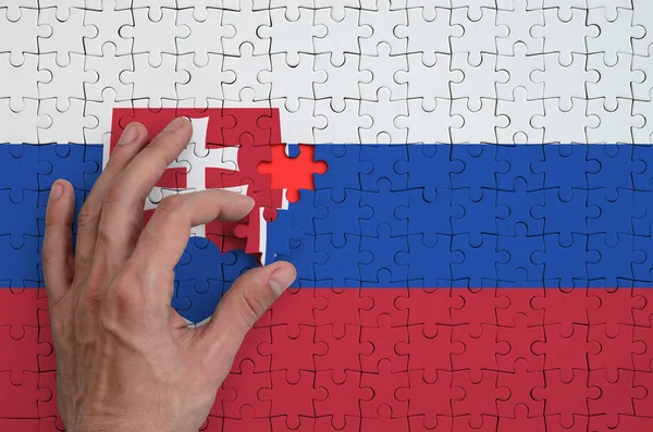 Slovakia Flag Depicted Puzzle Which Man Hand Completes Fold — Stock Photo, Image