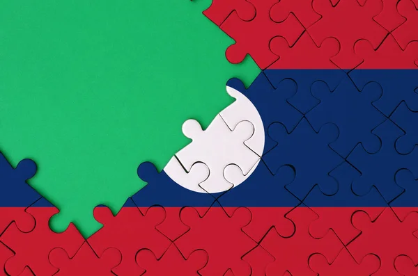 Die Laotische Flagge Ist Auf Einem Abgeschlossenen Puzzle Mit Freiem — Stockfoto