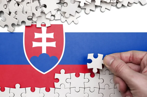 Slovakia Flag Depicted Table Which Human Hand Folds Puzzle White — Stock Photo, Image