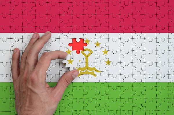 Tajikistan Flag Depicted Puzzle Which Man Hand Completes Fold — Stock Photo, Image