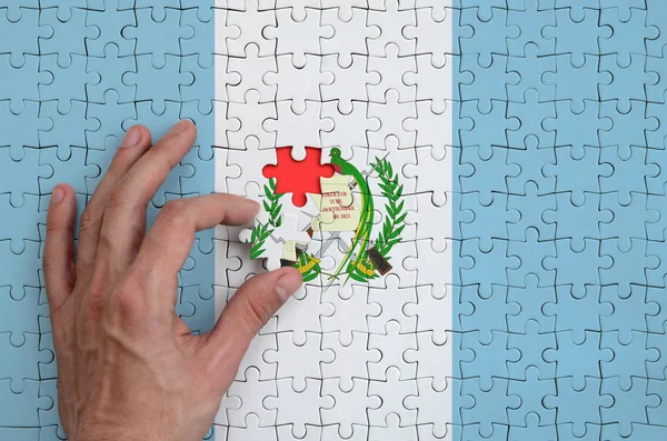 Guatemala Flag Depicted Puzzle Which Man Hand Completes Fold — Stock Photo