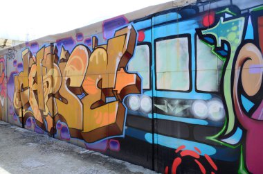 Sokak sanatı. Tam tamamlanan grafiti resmi bulunan bir metro treninin ile bej ve turuncu tonları arka plan görüntü.