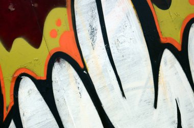 Sokak sanatı. Beyaz ve turuncu tonlarında renkli grafiti resmi bir parçasının arka plan görüntü.